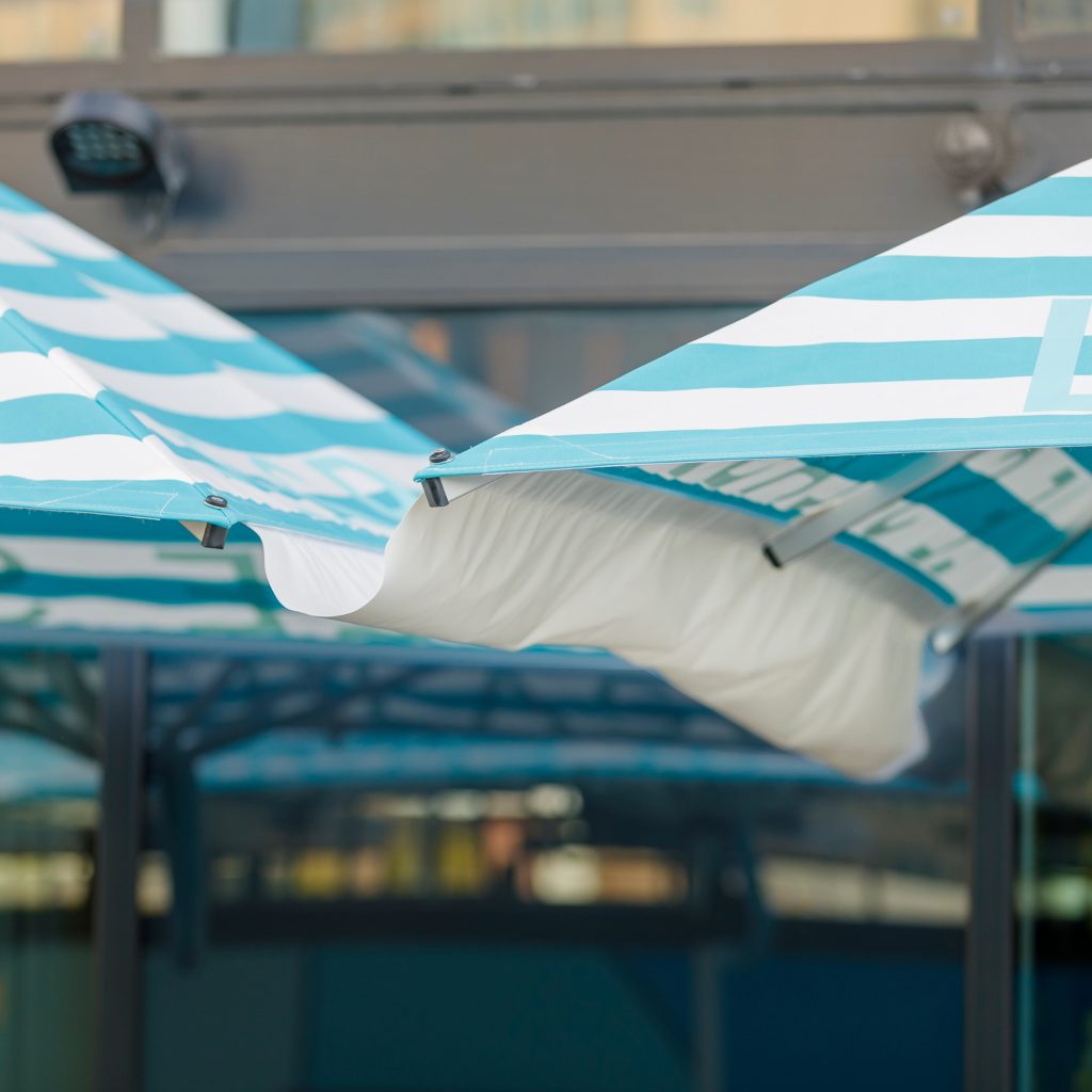 Two umbrellas connected by a gutter